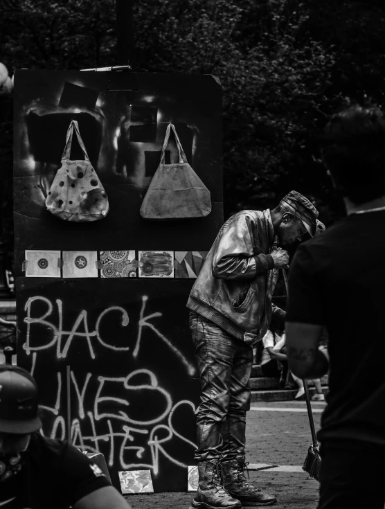 a woman stands next to a large display of black and white objects