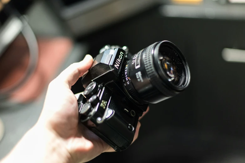 a person holding up a camera taking pictures