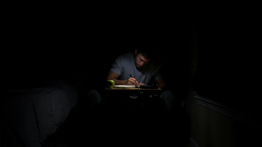 man working on his computer in the dark