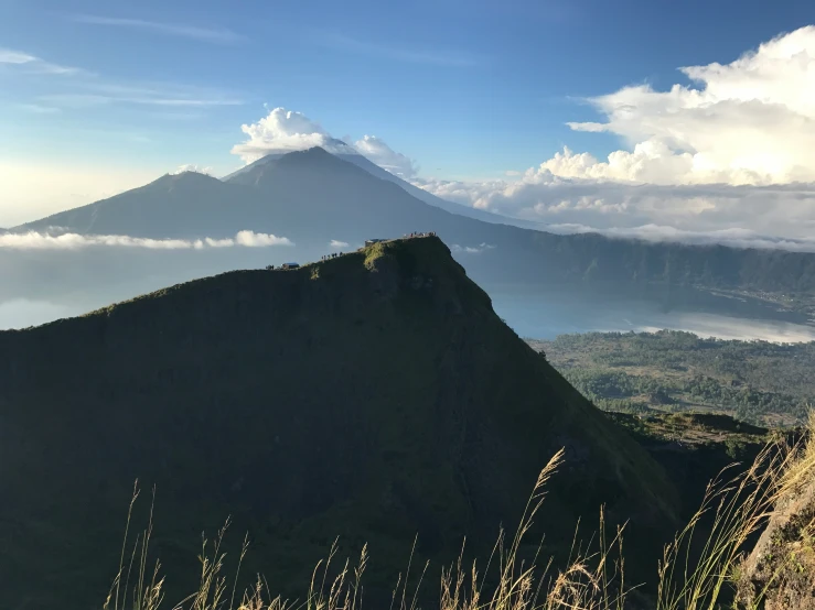 the mountain is covered in fog under a partly cloudy sky