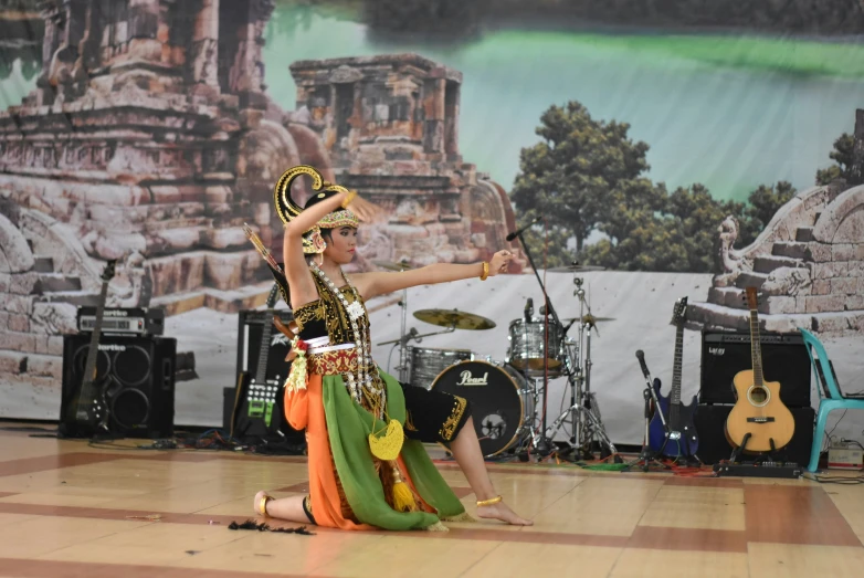 a young couple performs dance in front of stage