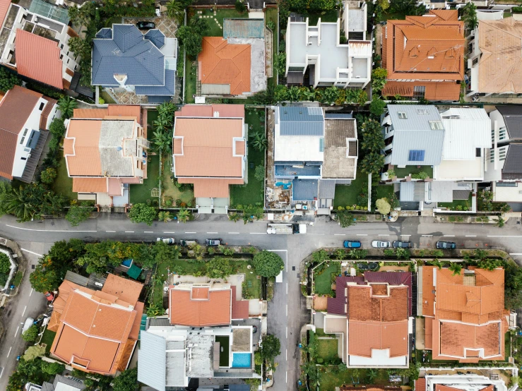 an aerial view of several roofed homes in a city