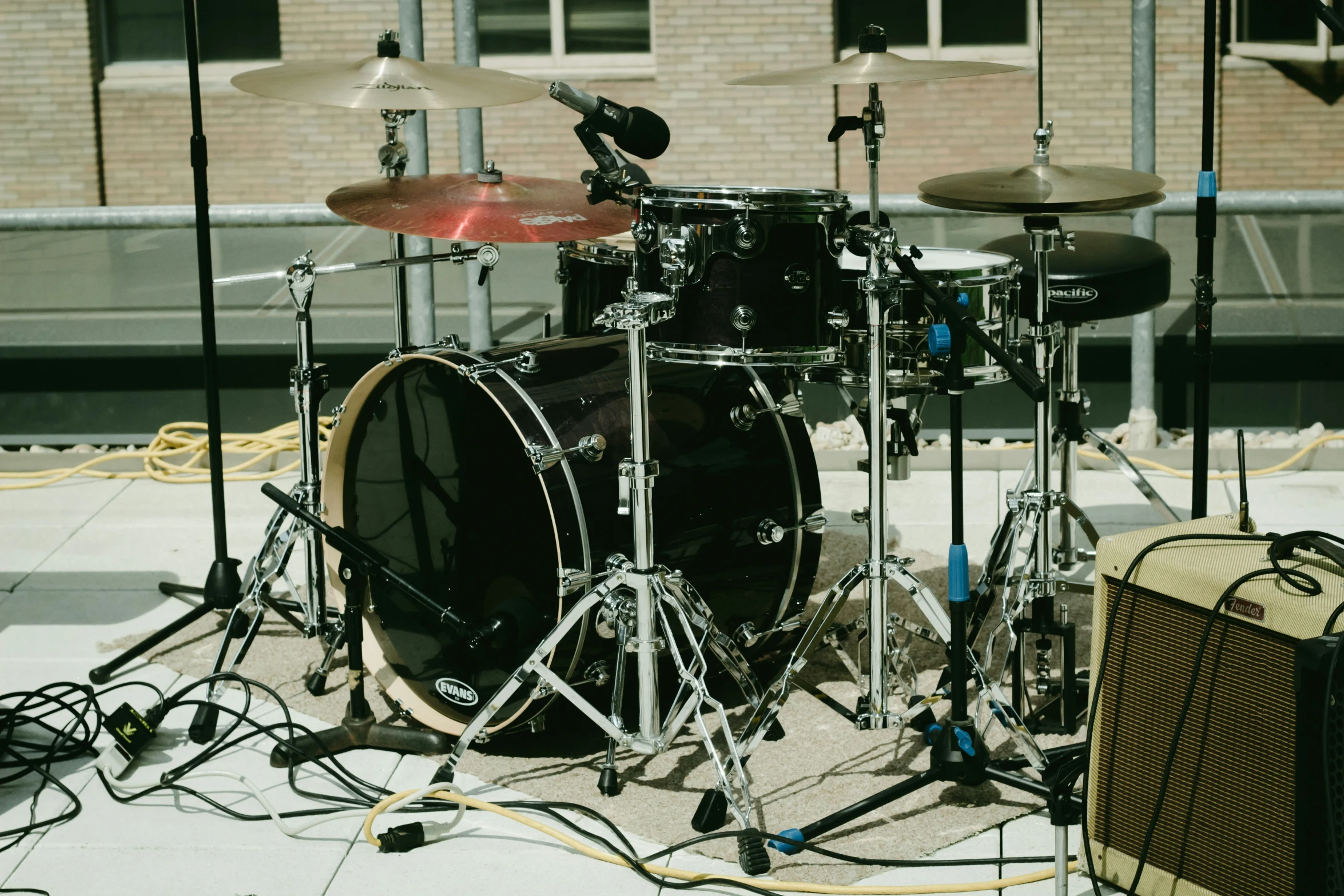 a drum kit sits on a street corner