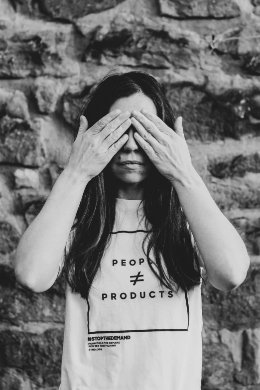 a girl covering her eyes in the shape of a t - shirt