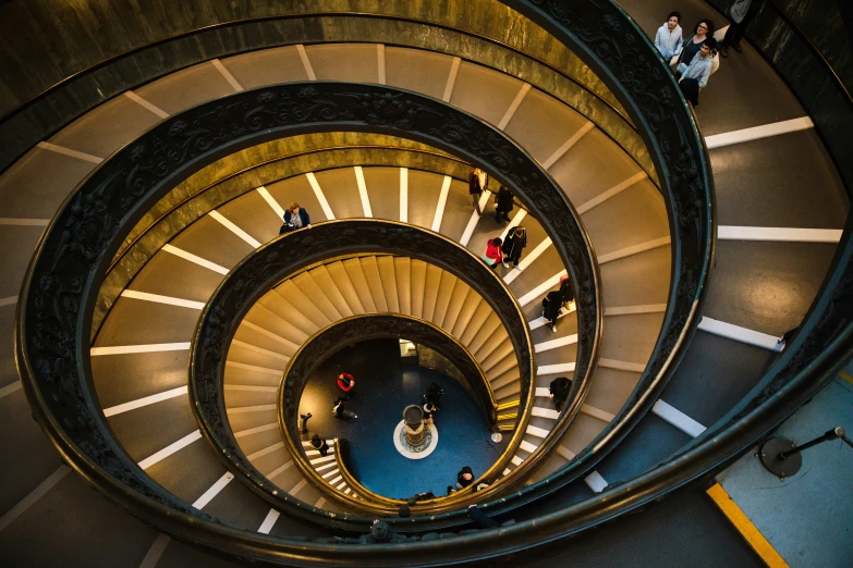 a view from the top of a spiral staircase looking down