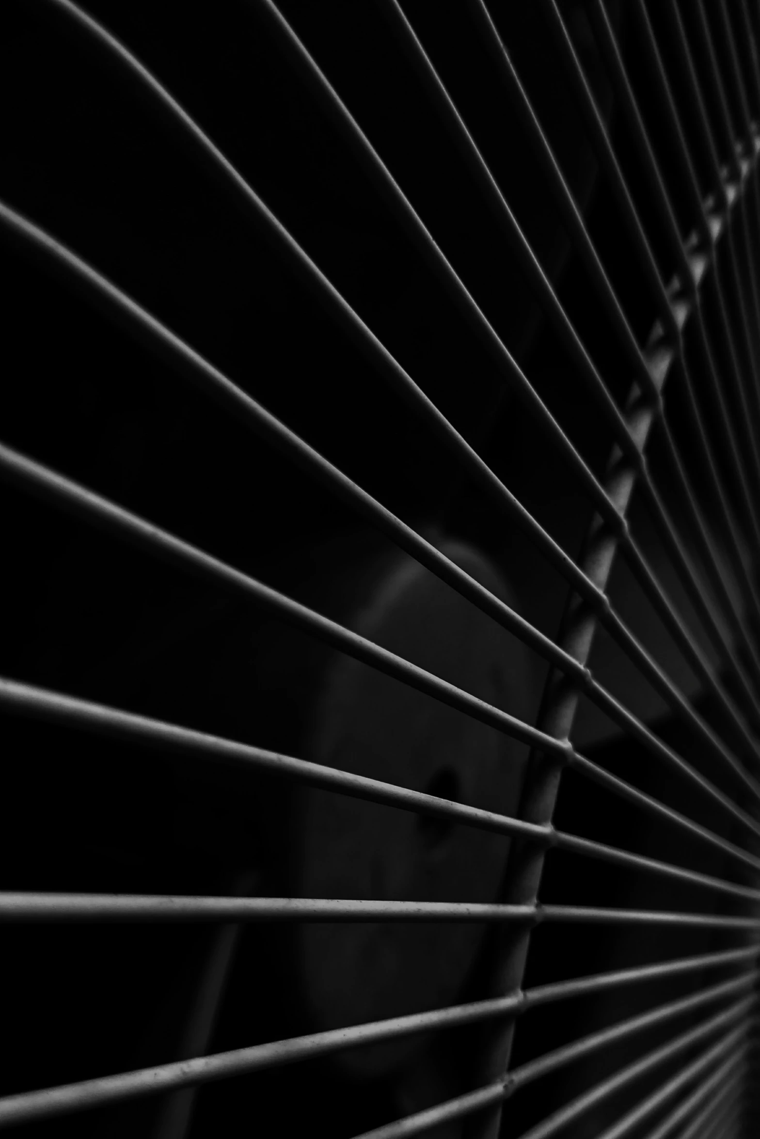 a close up of a fan with long white blinds