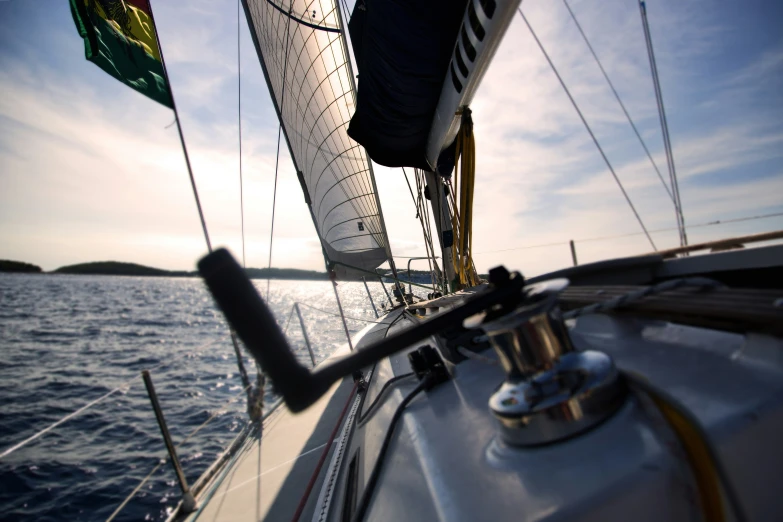 view from a sailboat at the bow looking toward mountains in distance