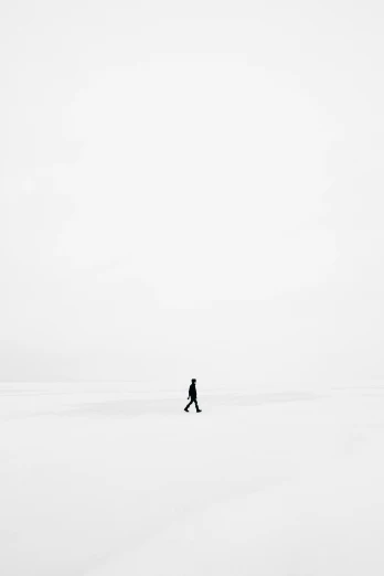 a person walking through the snow covered ground