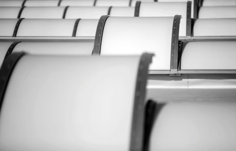 a row of chairs that are mostly white