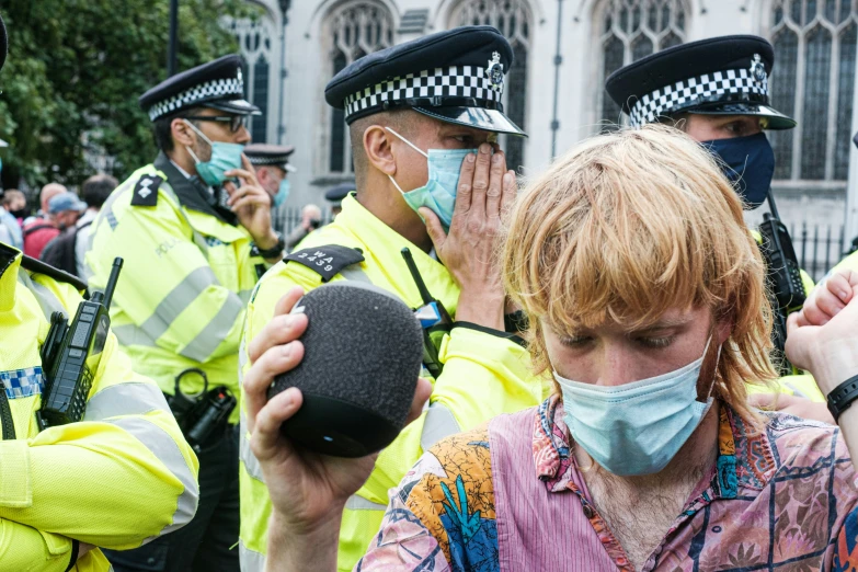 police officers stand at attention wearing face masks