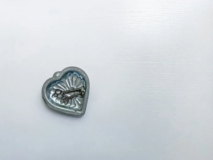 a small metal heart is shown on the side