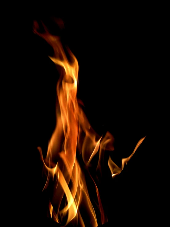 a blurry pograph of fire flames on a black background