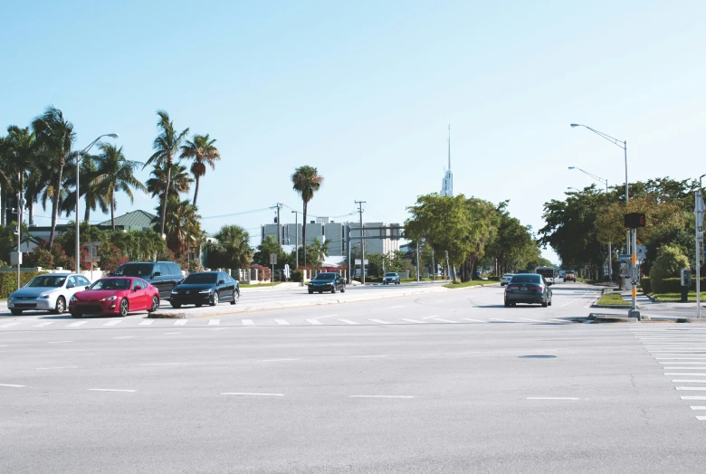 many cars are stopped at a red light in an empty street