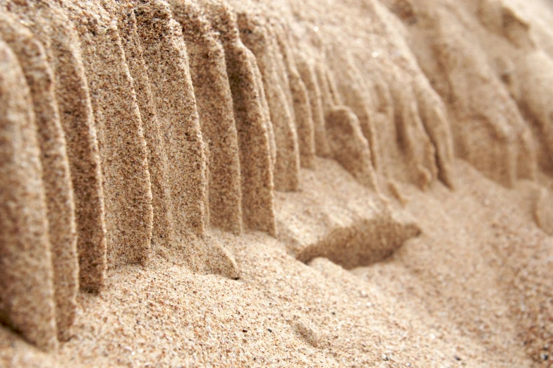 an image of sand made into a wavy line