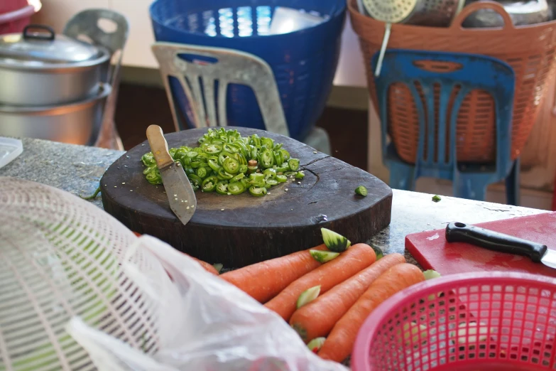 a knife and some carrots sitting on a table