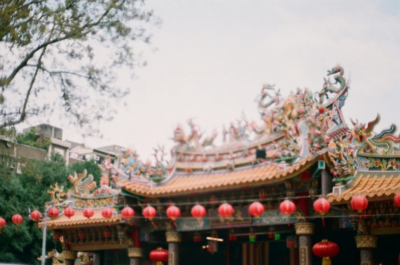 many red and white lanterns hanging over a building