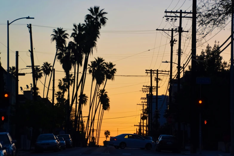 a sunset view from a car on a street