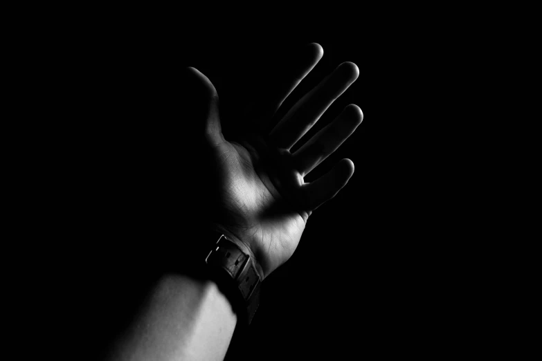 black and white image of hands extended out for the camera