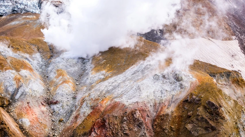 an aerial view of mountains that have colored rocks