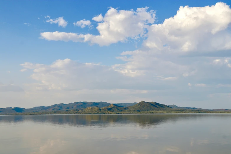a large lake with hills in the background