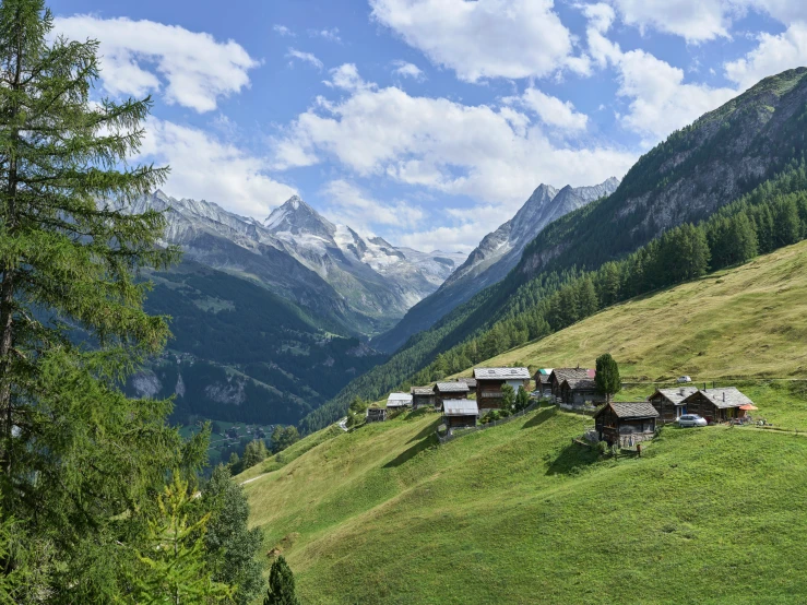 some houses are on the hill in the mountains