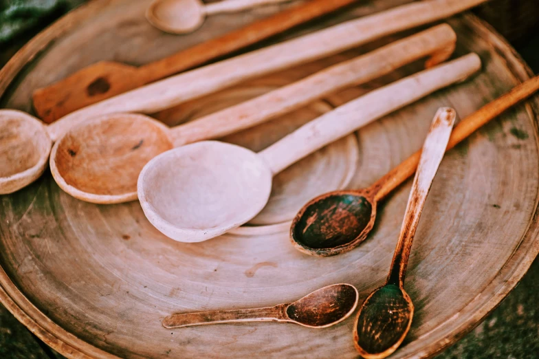 spoons, bowls and wooden spoons on a circular surface
