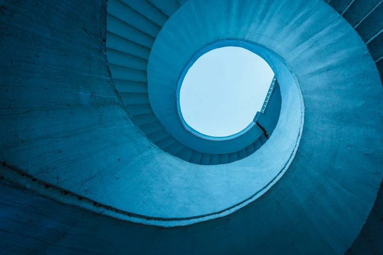 a circular stairway with a skylight in the middle