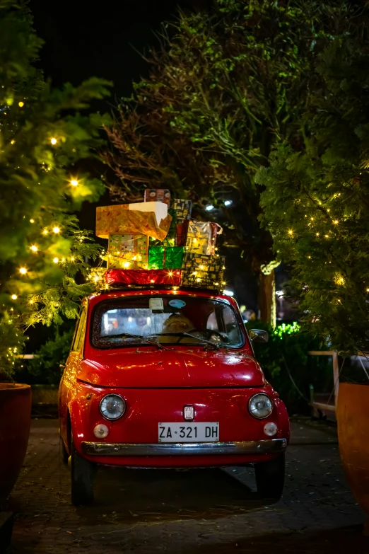 a car with a small red van covered in presents