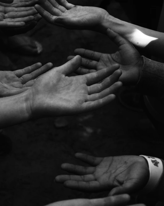 many hands together with one person showing the sign