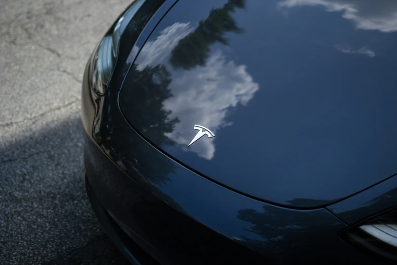 a closeup of the badge on a car that has a white lightning bolt on it