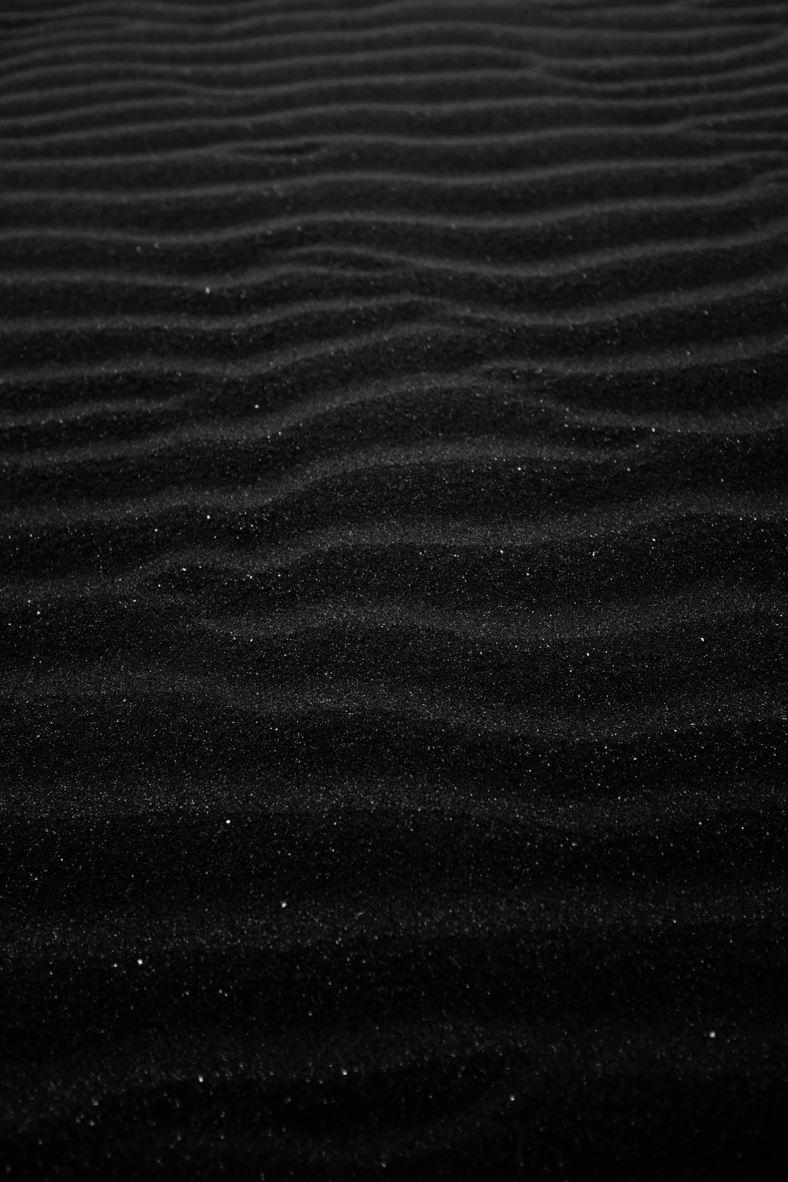 there is a black sand beach with a star pattern