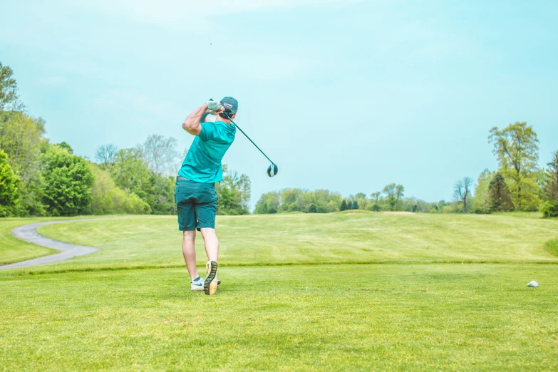 a man hitting a golf ball on a golf course