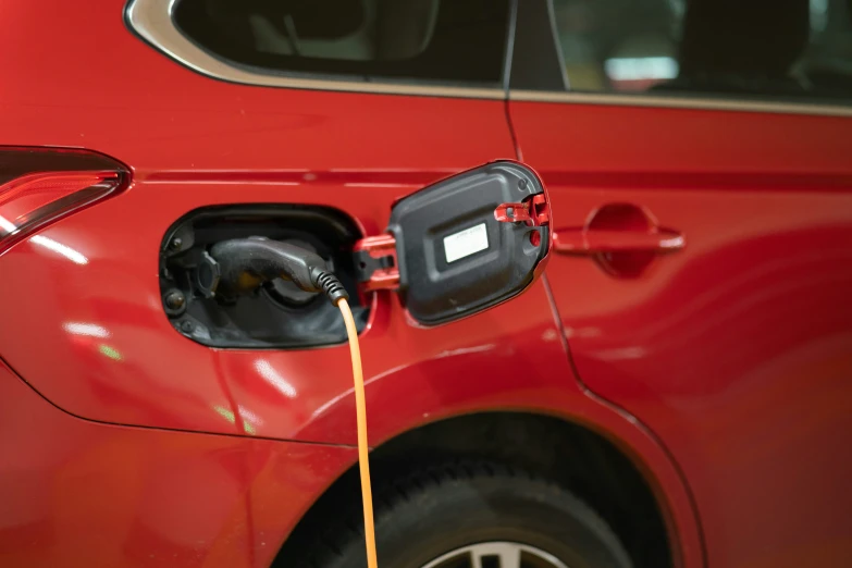 an electric car being fueled by a charger at a charging station