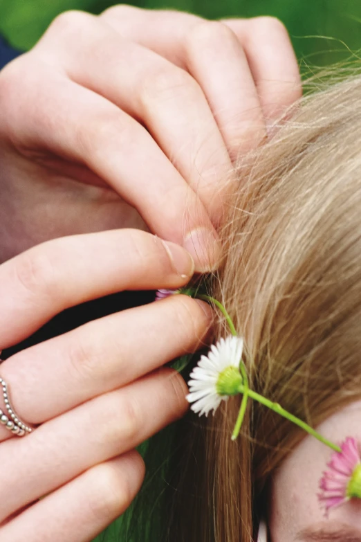 a  wearing jewelry with a daisies hair clip