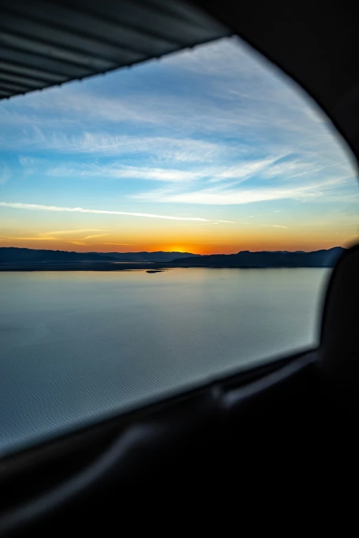 a window view of the water at sunset