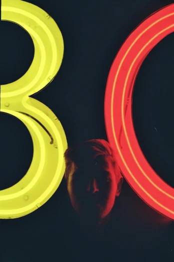 a neon circle is sitting beside a neon sign