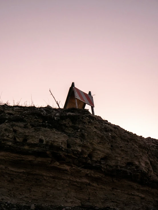 a small shack that is on a hillside