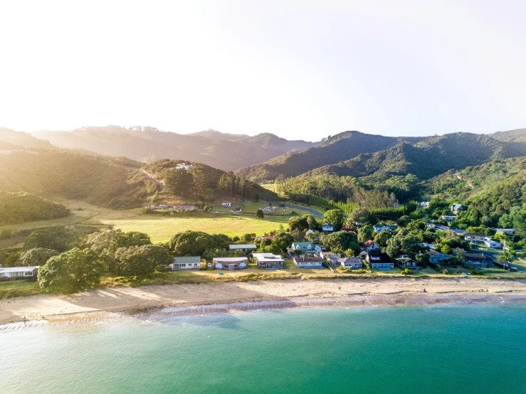 the aerial view of a small village on a beach