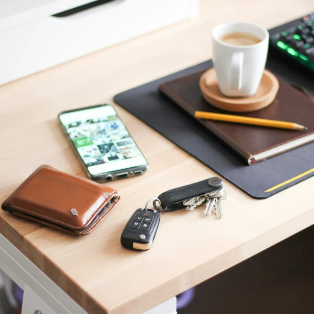 two different keys next to the remote and a coffee cup