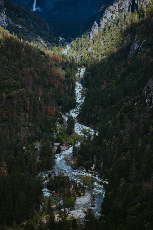 there is a river surrounded by mountains and trees