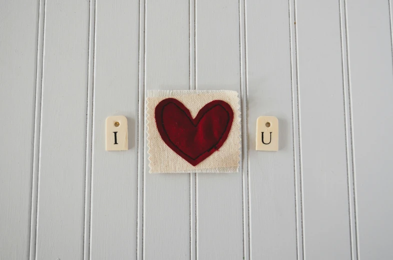 a wooden block that is made to look like a heart on a door