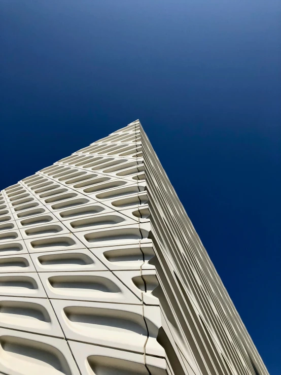 a tall building with an unusual look up into the sky