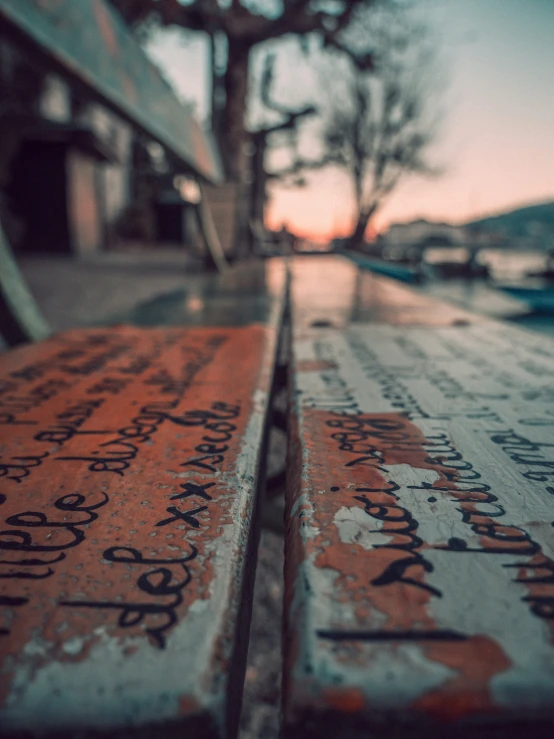 orange and white street signs sitting on the edge of an old road