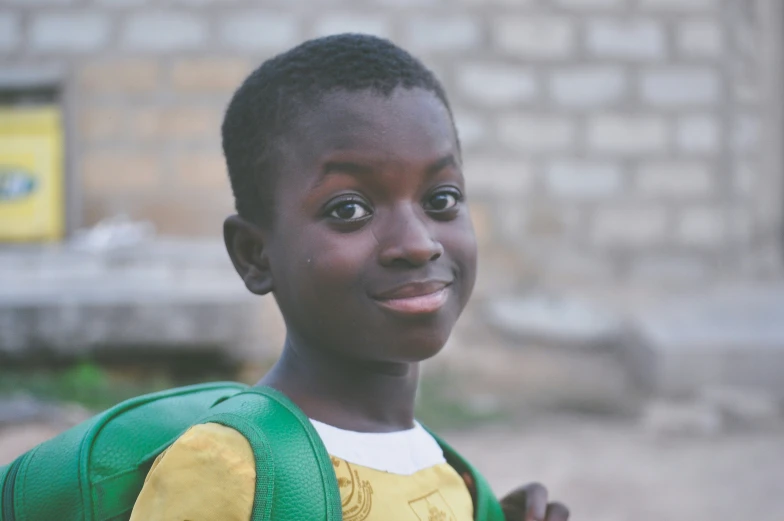 a close up of a child with a backpack