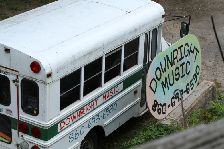 this school bus is parked next to a sign