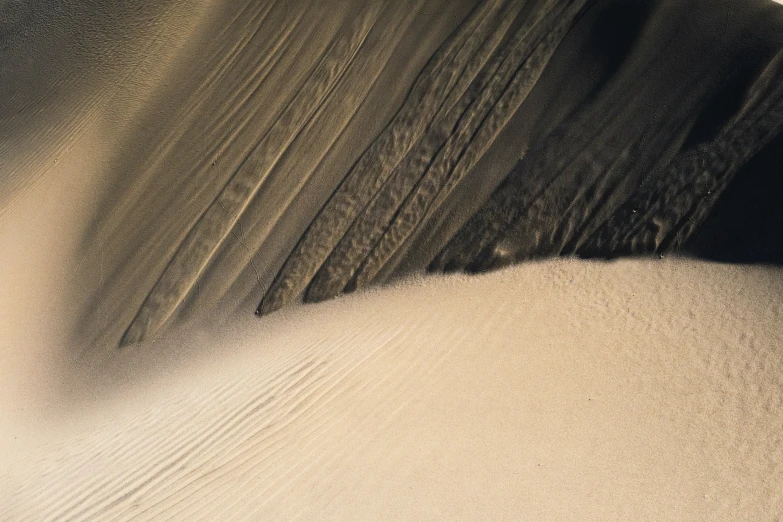 a wave moves over the sand in an abstract landscape