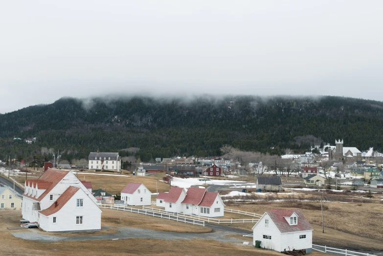 a large hill is covered in low fog