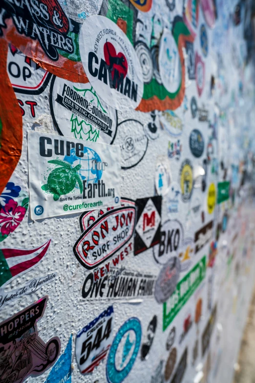 various stickers are on the wall in front of a building