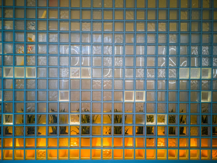a group of windows behind bars and a sign in the background