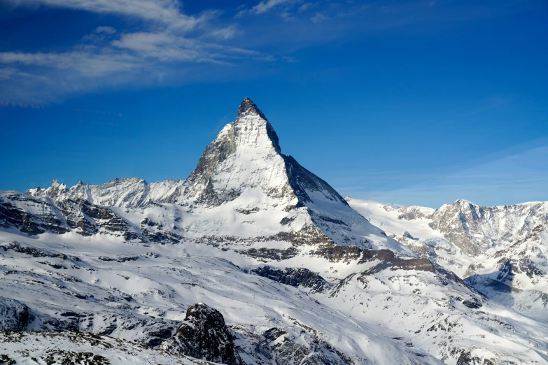 a snowy mountain peak surrounded by clouds